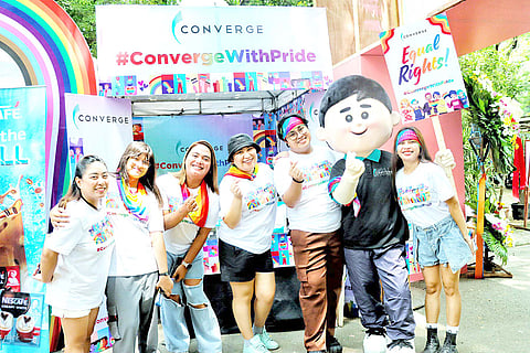 Converge employee-volunteers posed for a group photo with the brand mascot, Conrad.