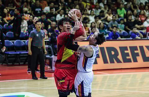 JUNE Mar Fajardo of San Miguel Beermen struggles against the defense of Cliff Hodge and Meralco during Game 3 of their PBA Philippine Cup best-of-seven finals series late Sunday at the Smart Araneta Coliseum.