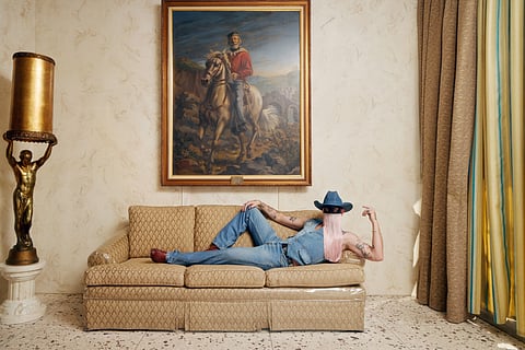 Orville Peck wearing Pride rodeo hat and reversible patchwork vest.