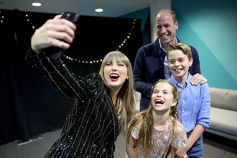 Prince William, Prince George and Princess Charlotte pose for a selfie with Taylor Swift.(Supplied: The Prince and Princess of Wales/X)