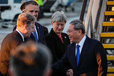 China's Premier Li Qiang (R) greets Australia's Foreign Minister Penny Wong (C), South Australia's Premier Peter Malinauskas (2nd L) and other officials at Adelaide Airport in Adelaide on June 15, 2024.