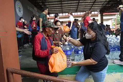 EVACUEE receives a bag of relief goods and water during #BrigadangAyala.