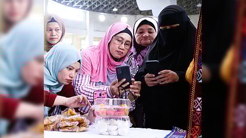 MARANAO women entrepreneurs create promotional videos of their snack products through their smartphones.