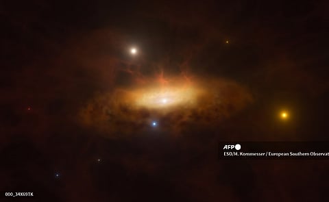 This handout artist’s impression obtained on June 18, 2024 from the European Southern Observatory (ESO) shows the growing disc of material being pulled in by the black hole as it feeds on the gas available in surroundings of the galaxy SDSS1335+0728, making the galaxy light up. In late 2019, the galaxy SDSS1335+0728 suddenly started shining brighter than ever before and was classified as having an active galactic nucleus, powered by a massive black hole in the galaxy’s core. This is the first time the awakening of a massive black hole has been observed in real time.