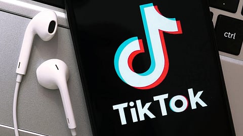 TikTok logo on a smartphone screen. Many critics claim that its parent company, ByteDance, uses the popular video-sharing app to monitor its users.