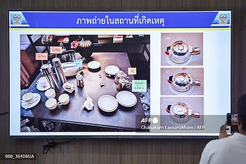 Members of the media look at images of drinks left in the room where six people were found dead the day before allegedly due to poisoning, during a press conference at Lumpini Police Station in Bangkok on July 17, 2024. One of the six foreigners found dead in a luxury hotel room in Bangkok is believed to have committed the murders using cyanide, Thai police said on July 17.
Chanakarn Laosarakham / AFP