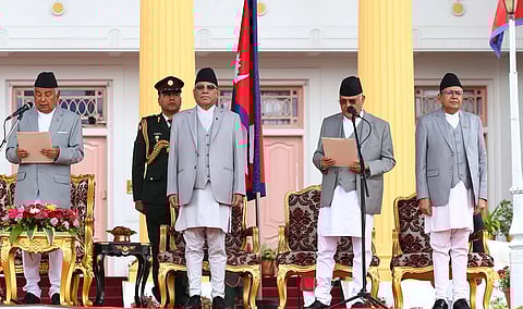 Nepal’s newly appointed prime minister Khadga Prasad Sharma Oli (second from right) takes oath of office, administered by President Ram Chandra Poudel (left) at the presidential house in Kathmandu.