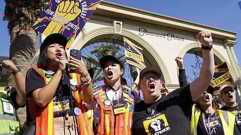 FILE - SAG-AFTRA captains Iris Liu, left, and Miki Yamashita, center, and SAG-AFTRA chief negotiator Duncan Crabtree-Ireland lead a cheer for striking actors outside Paramount Pictures studio, Nov. 3, 2023, in Los Angeles. Hollywood’s video game performers voted to go on strike Thursday, July 25, 2024, throwing part of the entertainment industry into another work stoppage after talks for a new contract with major game studios broke down over artificial intelligence protections.