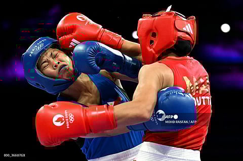 AIRA Villegas (left) exchanges punches with Yasmine Mouttaki of Morocco in the Round of 32 of the women’s 50-kilogram class at the North Paris Arena. Villegas prevailed via unanimous decision.