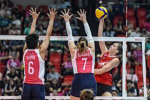 Russian import Elena Samoilenko of PLDT attacks the defense of Pangs Panaga and Michele Gumabao of Creamline in their PVL Reinforced Conference showdown late Tuesday at the Philsports Arena in Pasig City.