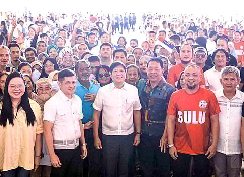 President Ferdinand ‘Bongbong’ Marcos Jr. (center) is accompanied by Sulu residents and local government officials after he handed out a P10-million financial assistance to the Jolo capital.
