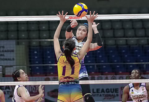 National University’s Sheena Toring penetrates the block of University of Southern Philippines Foundation’s Dya Mejos in their SSL National Invitationals quarterfinals match at the Ninoy Aquino Stadium.