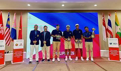 MEMBERS of the national team celebrate after reclaiming the Putra Cup trophy at the Seletar Country Club in Singapore. Shown are (from right) national coach Boyet Zaragosa, Jet Hernandez, Enrique Dimayuga, Carl Corpus and NGAP secretary general Bones Floro with a tournament official from the Singapore Golf Association.