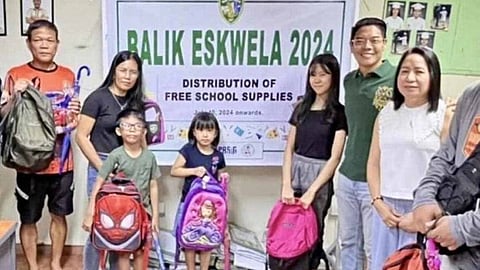 BARANGAY San Antonio chairman Raymond Lising leads the distribution of free school supplies to nearly 2,000 students of their village in Pasig City.