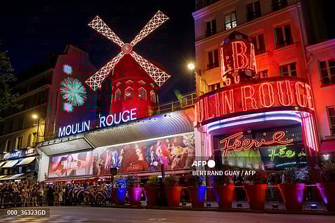 This photograph shows a general view of the "Moulin Rouge" cabaret, ahead of the inauguration of the theatre's windmill sails in Paris on July 5, 2024, an event that marks the return of the cabaret lights ahead of the Paris 2024 Olympic Games after the collapse of the former windmill sails last April.
BERTRAND GUAY / AFP