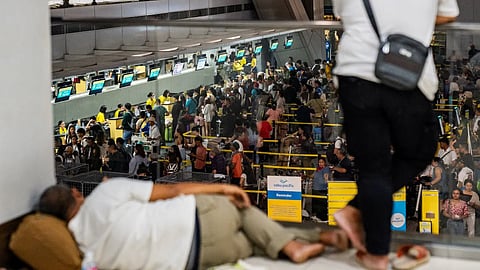 AirAsia passengers wait to be checked in manually at Kuala Lumpur International Airport's Terminal 2, after a global IT system outage, in Sepang, Malaysia, July 19, 2024.