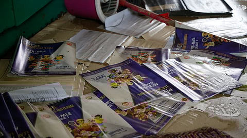 Save the Children Philippines staff inspects a classroom at Tinajeros Elementary School in Malabon City after heavy rainfall caused knee-high flooding and submerged learning materials. These were supposed to be distributed on the first day of classes on Monday, 29 July 2024.