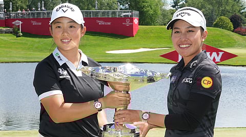 RUONING Yin of China (left) and Atthaya Thitikul of Thailand display the champion trophies.