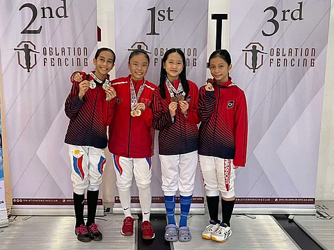 WILLA Galvez of the University of the East (second from left) displays her two medals with Christine Morales, Jonie Ching and Yuna Canlas following their participation in the Oblation Fencing Cup.