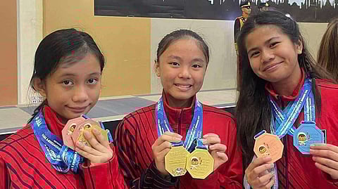 University of the East fencers (from left) Yuna Canlas and Willa Galvez and Elise Acuzar show the medals they won for the Philippines representing Canlas Fencing in the Thailand Fencing Festival Minime and Veterans Championships 2024 held in Zeer Rangsit, Thailand.