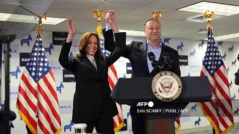 US Vice President and Democratic presidential candidate Kamala Harris and Second Gentleman Doug Emhoff acknowledge the crowd before Harris spoke at her campaign headquarters in Wilmington, Delaware, on July 22, 2024. Harris on Monday compared her election rival Donald Trump to "predators" and "cheaters," as she attacked the first former US leader to be convicted of a crime.