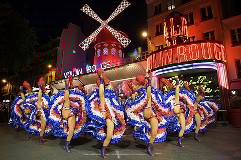 DANCERS perform in front of the Moulin Rouge cabaret during the inauguration of the theatre’s windmill sails in Paris, an event that marks the return of the cabaret lights ahead of the Paris 2024 Olympic Games .