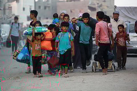 Displaced Palestinians leave an area of east Khan Younis after the Israeli army issued an evacuation order for parts of the city and Rafah, in the southern Gaza Strip.