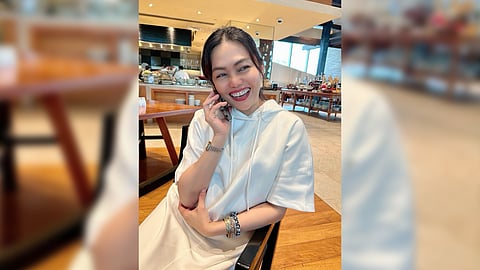 the author in an all-white long hooded dress; and (left) the black version.