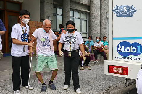 CGHC freshmen lead a patient to a mobile clinic for his lab tests.