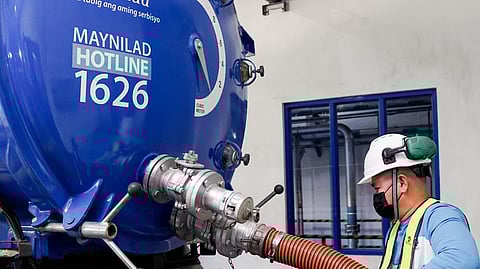 A Maynilad technician readies to provide free septic tank cleaning services with specialized equipment.