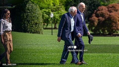 (FILES) US President Joe Biden walks with US Senator Bernie Sanders, Independent of Vermont, and Representative Alexandria Ocasio Cortez, Democrat of New York, on the South Lawn of the White House upon arrival in Washington, DC, on April 22, 2024. Sanders, a prominent figure of the US political left, voiced support for Joe Biden's presidential candidacy on July 13, 2024 despite calls for him to withdraw over health concerns.