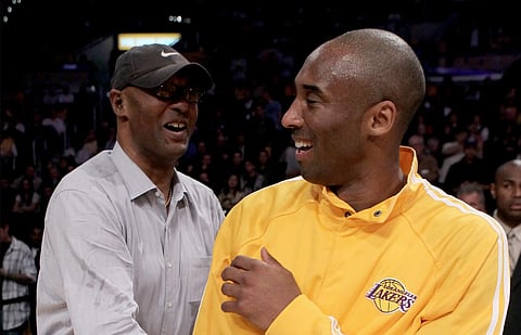 NBA Legend Kobe Bryant poses courtside with his father, the late Joe "Jellybean" Bryant