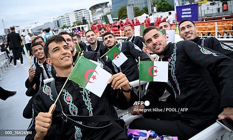 Paris 2024 Olympics - Opening Ceremony - Paris, France - July 26, 2024. Athletes of Algeria pose with flags ahead of the opening ceremony.
