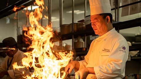Chef Dicky Suen perfects his craft over a flaming wok at Red Spice
