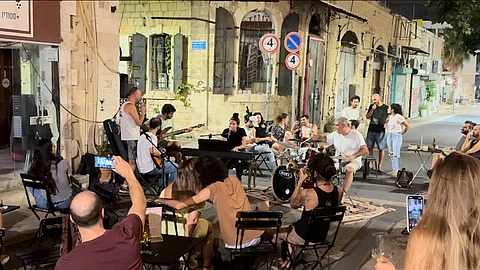Outside of the conflict zone, Israelis try to keep their lives as normal as possible but they are kept reminded of the horrors of the ongoing terrorism that started on 7 October last year through the images of those who perished in the war on many street walls.