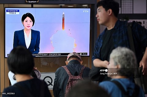 A man walks past a television screen showing a news broadcast with file footage of a North Korean missile test, at a train station in Seoul. North Korea on 1 July launched two ballistic missiles, South Korea’s military confirmed — the latest in a series of weapons tests by Pyongyang that have soured relations with Seoul.