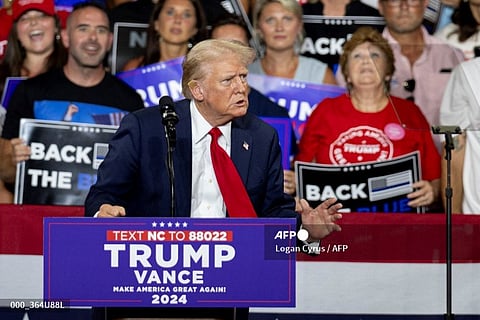 Former US President and 2024 Republican presidential candidate Donald Trump, a bandage on his ear after being injured during an assassination attempt, speaks during a campaign rally at the Bojangles Coliseum in Charlotte, North Carolina, on July 24, 2024.