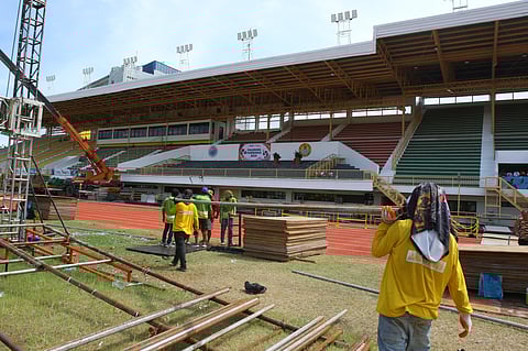 WORKERS lay down the final touches at the Cebu City Sports Center which will be the main hub of competition in this year’s Palarong Pambansa.