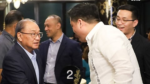 DSWD Secretary Rex Gatchalian (2nd from right) and PLDT-Smart president and CEO and Kain Tayo Pilipinas chairperson Manuel V. Pangilinan seal the private-public partnership against hunger with a handshake as PBSP executive director Elvin Ivan Uy (right) looks on at the KTP launching ceremony on 17 July 2024 in Makati City.