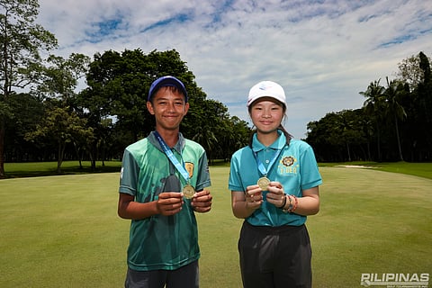 AJ Wacan (left) and Johanna Uyking display their medals after winning the 13-15 division titles of the ICTSI JPGT Mindanao Series I at the Apo Golf and Country Club.
