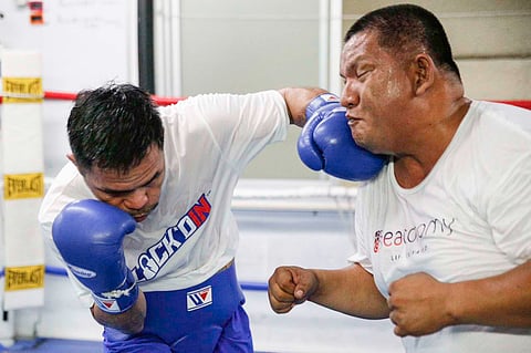 Manny Pacquiao unintentionally hits lead trainer Buboy Fernandez during training on Wednesday at the Kyokuto Gym in Tokyo. Pacquiao fights an exhibition match this Sunday at the Saitama Super Arena.