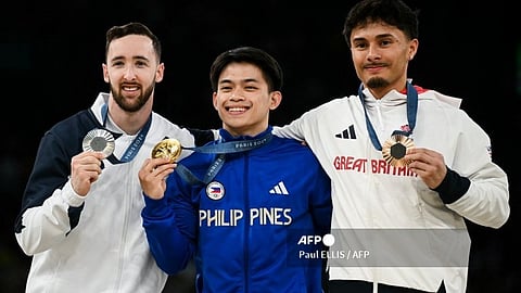 (LtoR) Israel's Artem Dolgopyat (silver), Philippines' Carlos Edriel Yulo (gold), and Britain's Jake Jarman (bronze) pose during the podium ceremony for the artistic gymnastics men's floor exercise during the Paris 2024 Olympic Games at the Bercy Arena in Paris, on August 3, 2024.