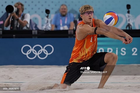 Netherlands' #01 Steven Van De Velde digs the ball in the men's round of 16 beach volleyball match between Brazil and Netherlands during the Paris 2024 Olympic Games at the Eiffel Tower Stadium in Paris on August 4, 2024.