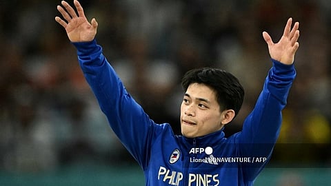 Philippines' Carlos Edriel Yulo celebrates winning the gold medal during the podium ceremony for the artistic gymnastics men's floor exercise during the Paris 2024 Olympic Games at the Bercy Arena in Paris, on August 3, 2024.