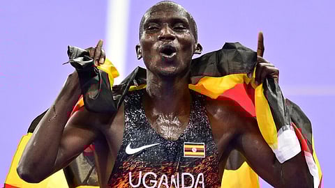 Uganda's Joshua Cheptegei celebrates victory in the men's 10,000m