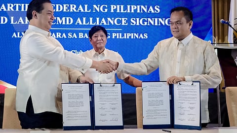 (FILES) President Ferdinand Marcos Jr. stands between Speaker Martin Romualdez of the Lakas-CMD party and South Cotabato Gov. Reynaldo Tamayo Jr., president of Partido Federal ng Pilipinas, after the signing of an agreement to cement the alliance of both political parties.