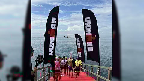 Participating in the IRONMAN 70.3 get their practice run in the 1.9-kilometer swim