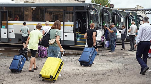 This handout photograph taken and released by the government of the Kursk region of Russia on August 9, 2024 shows women and children being evacuated from the town of Rylsk in the region.