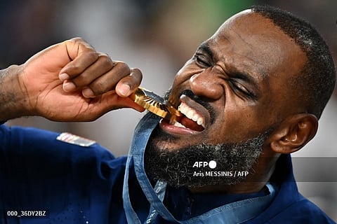 Gold medallist USA's #06 LeBron James poses on the podium after the men's Gold Medal basketball match between France and USA during the Paris 2024 Olympic Games at the Bercy Arena in Paris on August 10, 2024.