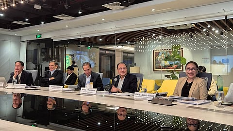 MPIC top executives, led by chairman, president and CEO Manuel V. Pangilinan (fourth from left on table), discuss first-half financial results.